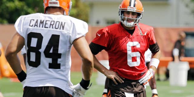 Cleveland Browns quarterback Brian Hoyer (6) talks to tight end Jordan Cameron (84) during practice at the NFL football team's facility in Berea, Ohio Wednesday, Sept. 3, 2014. (AP Photo/Mark Duncan)