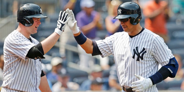 Yankees on-deck batter Brian McCan and Alex Rodriguez at Yankee Stadium in New York, Sunday, July 5, 2015.