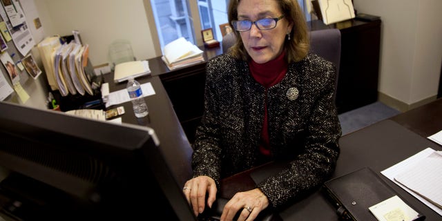 Lynn Feinberg, a caregiver expert at AARP, works in her office. (AP Photo/Evan Vucci)