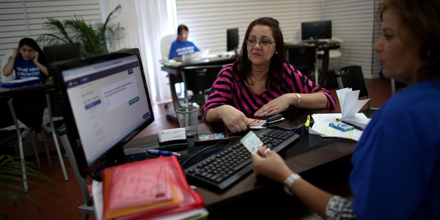 HIALEAH, FL - NOVEMBER 14: Ines Leyva works with Marlene Portuondo, an insurance agent with Sunshine Life and Health Advisors, as she looks to purchase an insurance policy under the Affordable Care Act at the store setup in the Westland Mall on November 14, 2013 in Hialeah, Florida. As the insurance agents continue to help people purchase and understand the policies offered under the Affordable Care Act, U.S. President Barack Obama announced that Americans who have had their health insurance plans canceled because of the Affordable Care Act can keep those plans for another year if they wish to. (Photo by Joe Raedle/Getty Images)