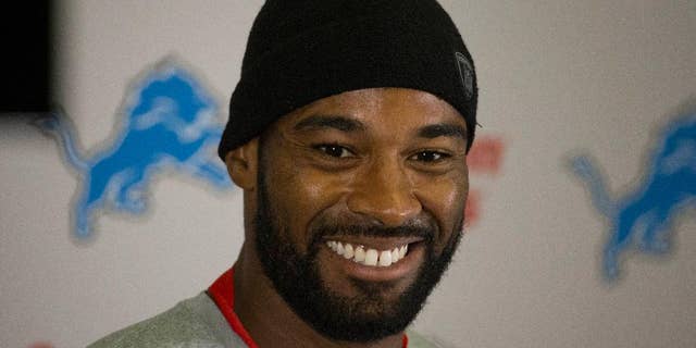 ADDS NAME OF PLAYER - Detroit Lions wide receiver Calvin Johnson smiles during a press conference at Pennyhill Park Hotel in Bagshot, England, Thursday, Oct. 23, 2014. The Atlanta Falcons will play the Detroit Lions in an NFL football game at London's Wembley Stadium on Sunday. (AP Photo/Matt Dunham)