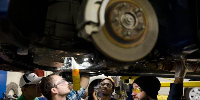 In this Oct. 23, 2014 photo, automotive service technology students work on a car at the Community College of Philadelphia, in Philadelphia. Payroll processor ADP reports how many jobs private employers added in October on Wednesday, Nov. 5, 2014. (AP Photo/Matt Rourke)