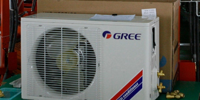 Employees work on the assembly line of the Gree Vietnam air conditioner factory in Vietnam's southern Binh Duong province June 8, 2008. REUTERS/Kham (VIETNAM)