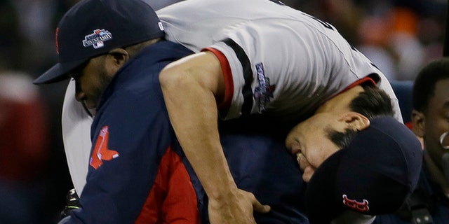 Boston Red Sox's David Ortiz picks up Koji Uehara after the Red Sox defeating the Detroit Tigers 4-3 in Game 5 of the American League baseball championship series Thursday, Oct. 17, 2013, in Detroit. (AP Photo/Matt Slocum)