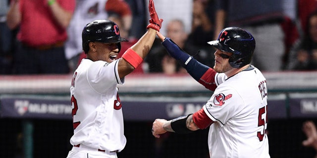 Cleveland Indians' Roberto Perez, right, celebrates with Francisco Lindor after scoring on a Jason Kipnis single against the Boston Red Sox in the fifth inning during Game 1 of baseball's American League Division Series, Thursday, Oct. 6, 2016, in Cleveland.