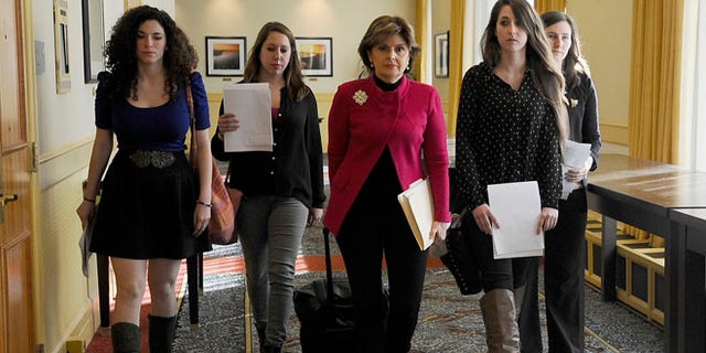 Oct. 21: Attorney Gloria Allred, center, walks with University of Connecticut students Rose Richi, left, Erica Daniels, Carolyn Luby, second from right, and Kylie Angell, right, to a news conference in Hartford.