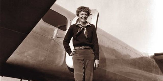 In this May 20, 1937 photo, provided by The Paragon Agency,shows aviator Amelia Earhart and her Electra plane, taken by Albert Bresnik at Burbank Airport in Burbank, Calif. It was a clear spring day in 1937 when Amelia Earhart, ready to make history by flying around the world, brought her personal photographer to a small Southern California airport to document the journey's beginning. (Albert Bresnik/The Paragon Agency via AP)