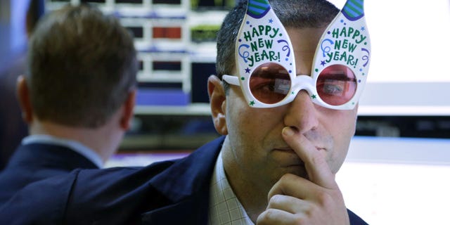 FILE -  In this Monday, Dec. 31, 2012, file photo, a trader wearing "Happy New Year" glasses works on the floor at the New York Stock Exchange in New York. According to an Associated Press-GfK poll released Monday, Dec. 16, 2013,  Americans dont expect another gangbuster year for the stock market. Of the people polled, 40 percent think the market will stabilize at current levels by the end of 2014, with 39 percent predicting that it will drop, but not crash. Only 14 percent believe the market will rise and 5 percent think that the market will crash (AP Photo/Seth Wenig, File)