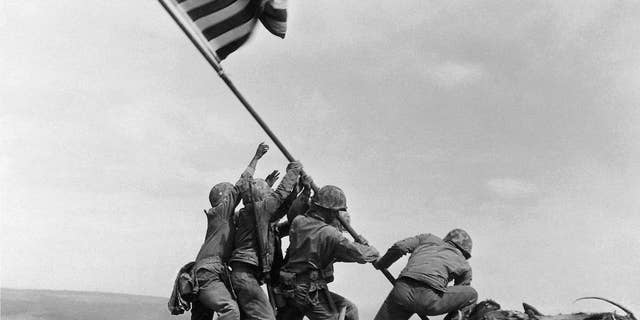 FILE - In this Feb. 23, 1945 file photo, U.S. Marines of the 28th Regiment, 5th Division, raise a U.S. flag atop Mount Suribachi, Iwo Jima. Strategically located 660 miles from Tokyo, the Pacific island became the site of one of the bloodiest, most famous battles of World War II against Japan. (AP Photo/Joe Rosenthal, File)