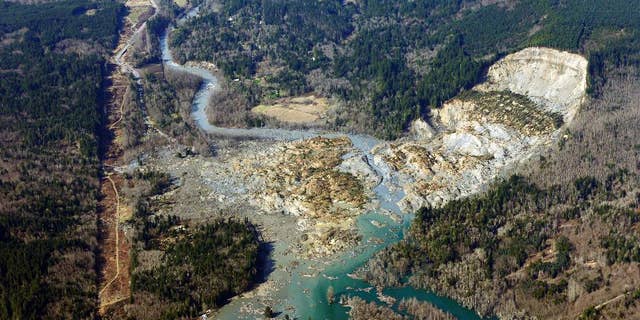 AP10ThingsToSee - This aerial photo taken Monday, March 24, 2014 shows the massive mudslide that killed at least eight people Saturday and left dozens missing, near Arlington, Wash. (AP Photo/Ted S. Warren, File)