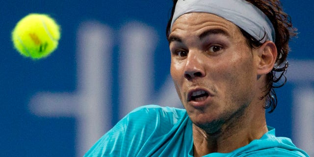 Rafael Nadal of Spain eyes on the ball as he plays against Santiago Giraldo of Colombia during their match of the China Open tennis tournament at the National Tennis Stadium in Beijing, China Tuesday, Oct. 1, 2013. (AP Photo/Andy Wong)