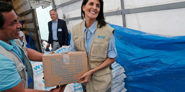 In this May 24 photo, U.S. Ambassador to the U.N. Nikki Haley holds a food parcel provided by the World Food Programme during a visit at the Reyhanli border crossing with Syria, near Hatay, southern Turkey.