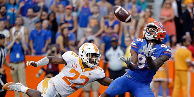 Florida wide receiver Tyrie Cleveland, right, catches the game winning 63-yard touchdown pass in front of Tennessee defensive back Micah Abernathy (22) as time expired in the fourth quarter of an NCAA college football game, Saturday.