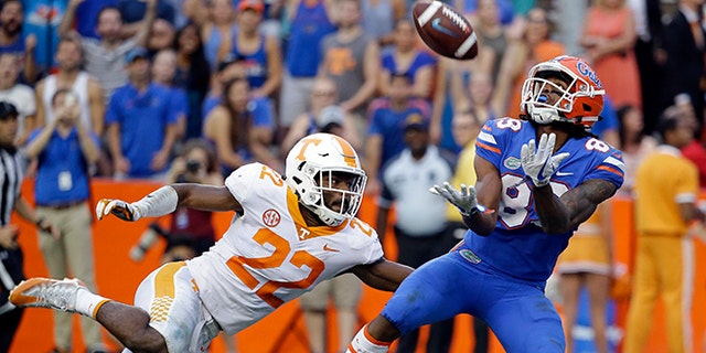 Florida wide receiver Tyrie Cleveland, right, catches the game winning 63-yard touchdown pass in front of Tennessee defensive back Micah Abernathy (22) as time expired in the fourth quarter of an NCAA college football game, Saturday.