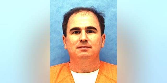 This undated photo made available by the Florida Department of Law Enforcement shows Eric Scott Branch in custody.