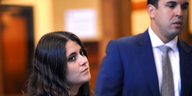 Standing beside her lawyer Ryan O'Neill, Nikki Yovino is sentenced one year in jail in Superior Court in Bridgeport, Conn. Thursday, Aug. 23, 2018 for making false rape accusations against two Sacred Heart University football players. Police say Yovino made up the claims because she thought the consensual encounter would damage her relationship with another student. (Brian A. Pounds/Hearst Connecticut Media via AP)