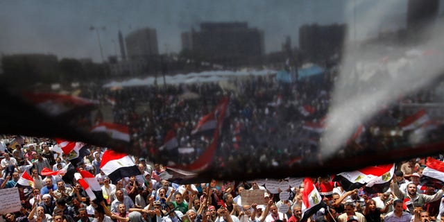 Opponents of Egypt's Islamist President Mohammed Morsi wave national flags as they demonstrate in Tahrir Square in Cairo, Egypt, Friday, June 28, 2013. (AP Photo/Amr Nabil)