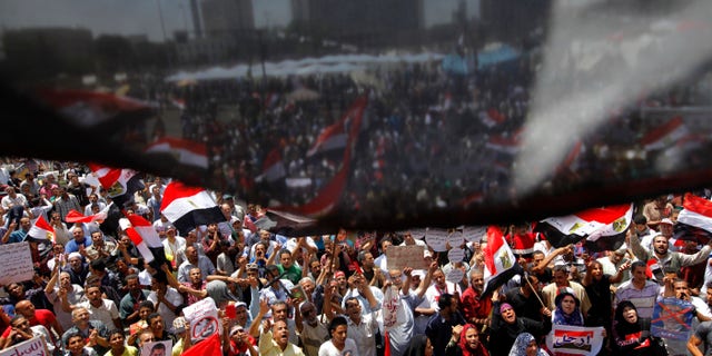 Opponents of Egypt's Islamist President Mohammed Morsi wave national flags as they demonstrate in Tahrir Square in Cairo, Egypt, Friday, June 28, 2013. (AP Photo/Amr Nabil)