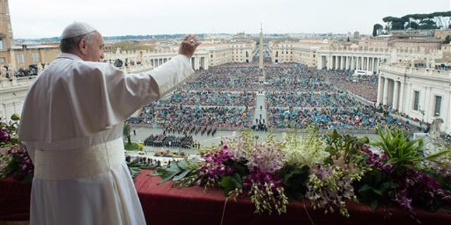 Pope Francis delivers the Urbi et Orbi (to the city and to the world) blessing at the end of the Easter Sunday Mass in St. Peter's Square at the Vatican, Sunday, April 5, 2015. (AP Photo/Osservatore Romano, Pool)