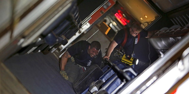 Personnel working on the inside of a train in the wreck