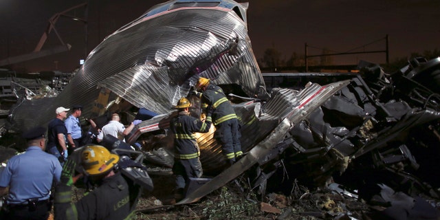 Personnel search through the scene of the wreck