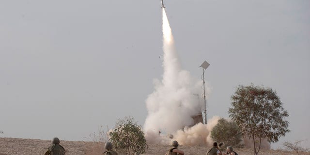 An Israeli Iron Dome missile is launched near the city of Be'er Sheva, southern Israel, to intercept a rocket fired from Gaza Saturday, Nov. 17, 2012. Israel bombarded the Hamas-ruled Gaza Strip with nearly 200 airstrikes early Saturday, the military said, widening a blistering assault on Gaza rocket operations to include the prime minister's headquarters, a police compound and a vast network of smuggling tunnels. (AP Photo/Ahikam Seri)