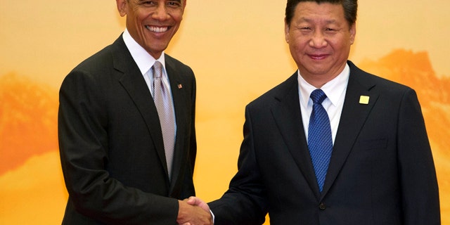 November 11, 2014: U.S. President Barack Obama, left, shakes hands with Chinese President Xi Jinping during a welcome ceremony for the Asia-Pacific Economic Cooperation (APEC) summit at the International Convention Center in Yanqi Lake, Beijing. (AP Photo/Ng Han Guan)