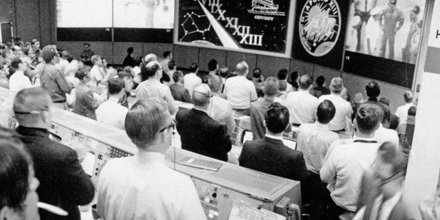 The view from NASA's Mission Operations Control Room as the Apollo 13 crew is welcomed aboard the USS Iwo Jima on April 17, 1970 following a perilous flight around the moon by astronauts James Lovell, Fred Haise and Jack Swigert.