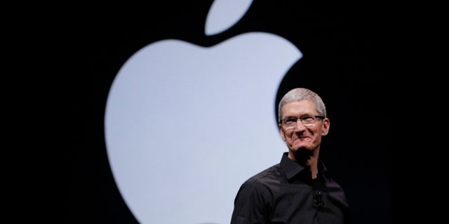 Apple CEO Tim Cook walks on stage at the beginning of an event in San Francisco, Sept. 12, 2012.