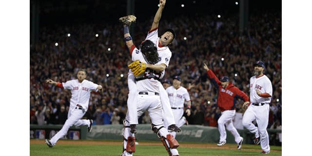 October 19, 2013: Boston Red Sox relief pitcher Koji Uehara, rear, and catcher Jarrod Saltalamacchia celebrate the Red Sox 5-2 win over the Detroit Tigers in Game 6 of the American League baseball championship series on Saturday, Oct. 19, 2013, in Boston. (AP Photo)