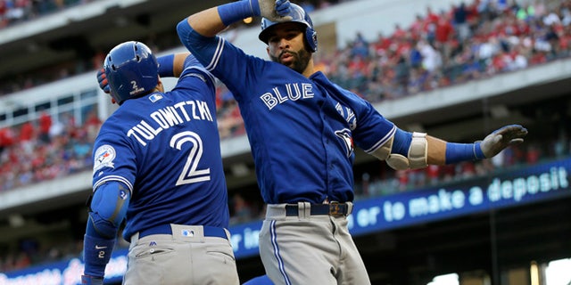 Toronto Blue Jays' Troy Tulowitzki and Jose Bautista celebrate on Oct. 6, 2016.