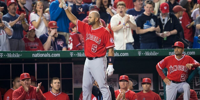 April 22, 2014: Albert Pujols (5) steps out of the visitors' dugout to acknowledge the applause from the crowd after hitting his 500th career home run off the Washington Nationals' Taylor Jordan in the fifth inning of the Los Angeles Angels' 7-2 win. (AP)