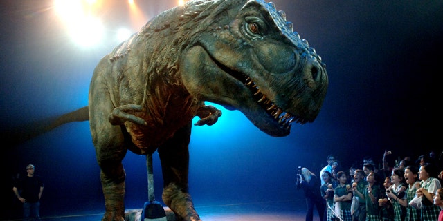 School children react as they stare at an animatronic dinosaur during a media call for the Walking with Dinosaurs arena spectacular in Sydney, Monday, Oct. 18, 2010. Australia's most successful entertainment export, the life-sized dinosaurs have played to six and half million people worldwide and generated more than $344 million U.S. in ticket sales.