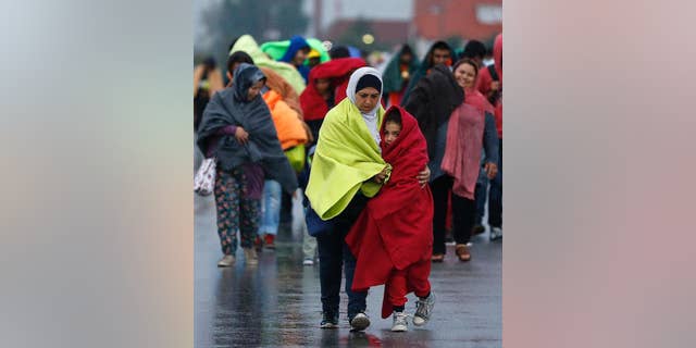 Migrants arrive at the Hungarian-Austrian border in Nickelsdorf, Austria, Saturday, Sept. 5, 2015, where they came from Budapest as Austria in the early-morning hours said it and Germany would let them in.