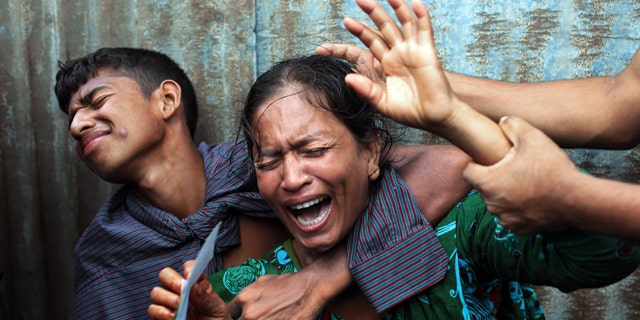 August 4, 2014: Bangladeshi woman Munni, whose daughters are missing, cries as rescuers search the River Padma after a passenger ferry capsized in Munshiganj district. (AP Photo/ A.M. Ahad)