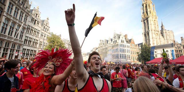 Belgian fans cheer after Belgium scored a goal as they watch the soccer match on a giant screen in the Grote Markt in Antwerp, Belgium on Sunday, June 22, 2014. Belgium scored a 1-0 victory over Russia during the group H World Cup soccer match between Belgium and Russia at the Maracana Stadium in Rio de Janeiro, Brazil. (AP Photo/Virginia Mayo)