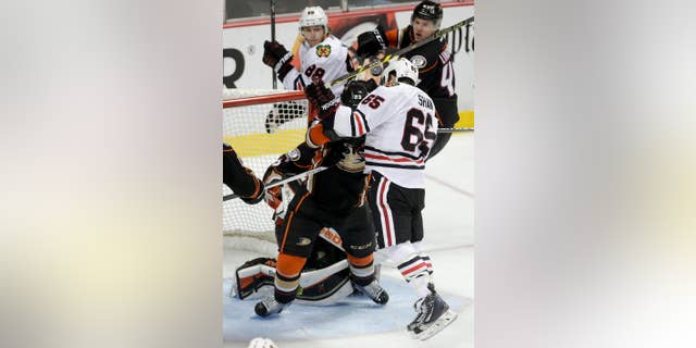 Chicago Blackhawks center Andrew Shaw head-butts the puck into the goal during overtime in Game 2 of the Western Conference final during the NHL hockey Stanley Cup playoffs against the Anaheim Ducks in Anaheim, Calif., on Tuesday, May 19, 2015. The apparent goal was disallowed. (AP Photo/Jae C. Hong)