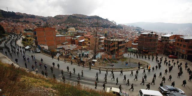 Low ranking soldiers march on the third day of protests in La Paz, Bolivia, Thursday, April 24, 2014. Enlisted soldiers are protesting the military high command's dismissal of four of its leaders who defended their call for changes so that non-commissioned officers may study to become career officers. (AP Photo/Juan Karita)