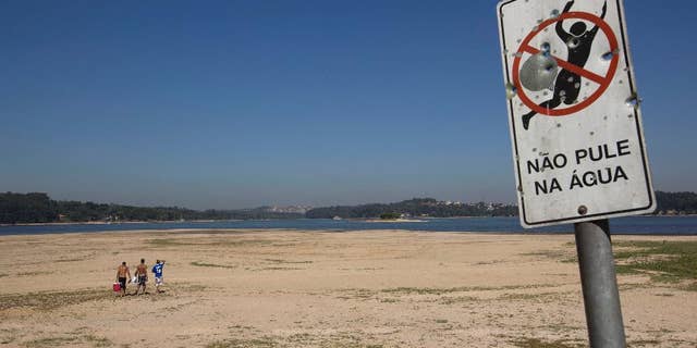Oct. 29, 2014: Men walk on the receding banks of the Guarapiranga dam which is responsible for providing water to the Sao Paulo metropolitan area in Brazil