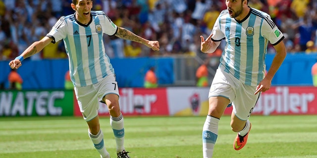July 5, 2014: Argentina's Gonzalo Higuain, right, celebrates with Angel di Maria after scoring the opening goal during the World Cup quarterfinal soccer match between Argentina and Belgium at the Estadio Nacional in Brasilia, Brazil. (AP Photo/Martin Meissner)