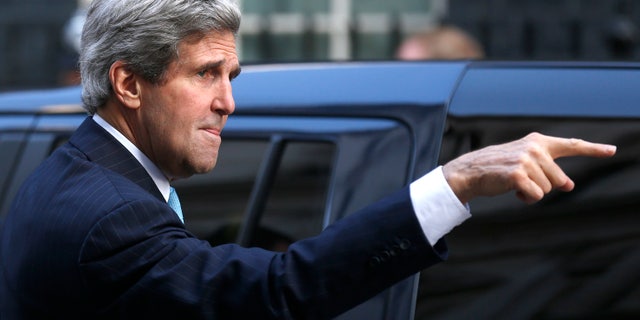 US Secretary of State John Kerry gestures as he arrives for a meeting with Britain's Prime Minister David Cameron and the Foreign Secretary William Hague at Downing street in London, Friday, March, 14, 2014. Kerry arrived in London Friday, for his last meeting with Russian Foreign Minister Sergey Lavrov before the Crimea vote. (AP Photo/Sang Tan)