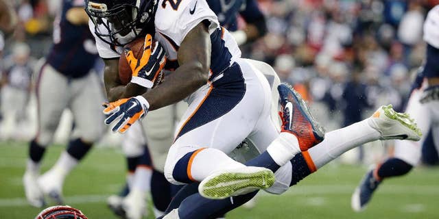 Denver Broncos running back Ronnie Hillman (23) leaps over a New England Patriots defender in the first half of an NFL football game on Sunday, Nov. 2, 2014, in Foxborough, Mass. (AP Photo/Steven Senne)