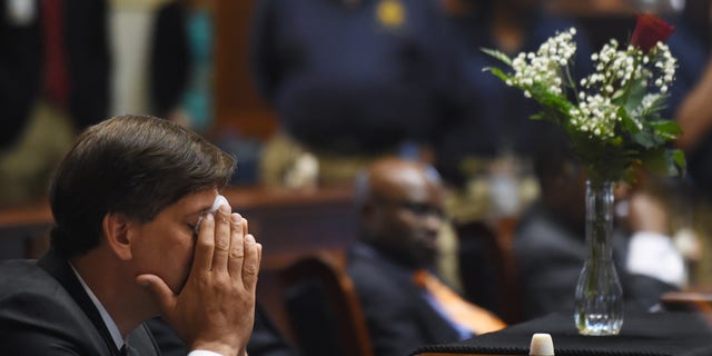 State Senator Vincent Sheheen (D-Kershaw) gets emtional as he sits next to the draped desk of state Sen. Clementa Pinckney, Thursday, June 18, 2015, at the Statehouse in Columbia, S.C.  Pinckney was one of those killed, Wednesday night in a shooting at the Emanuel AME Church in Charleston.  (AP Photo/Rainier Ehrhardt)
