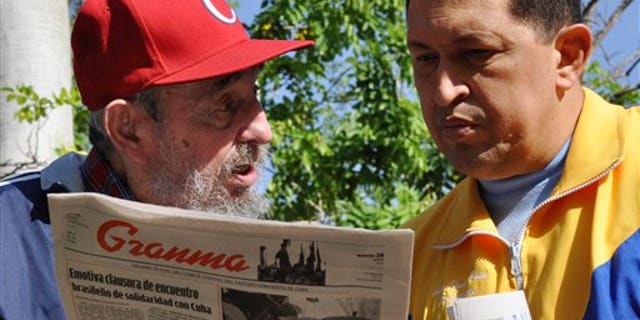 June 28: In this photo released by the state media Cubadebate web site, Cuba's Fidel Castro, left, and Venezuela's President Hugo Chavez look at Granma state newspaper at an unknown location in Havana, Cuba.