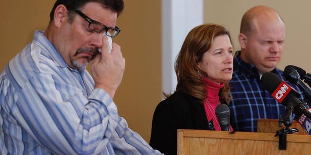 Will Corporon, left, and Tony Corporon, right, fight emotions while Mindy Losen, center, talks about her son and father during a news conference at their church in Leawood, Kan., Monday, April 14, 2014. Dr. William Corporon and his 14-year-old grandson were victims of Sunday's shooting at the Jewish Community Center. The three are sons and daughter of Dr. Corporon and Losen is the mother of the 14-year-old victim. (AP Photo/Orlin Wagner)