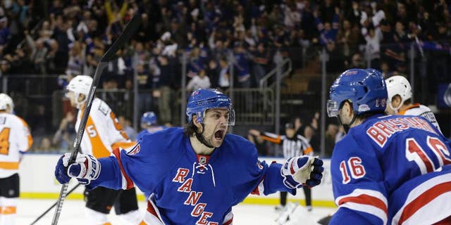 New York Rangers' Mats Zuccarello (36) and Derick Brassard (16) celebrate a goal by Benoit Pouliot during the second period in Game 7 of an NHL hockey first-round playoff series against the Philadelphia Flyers, Wednesday, April 30, 2014, in New York. (AP Photo)