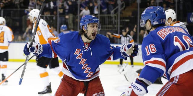 New York Rangers' Mats Zuccarello (36) and Derick Brassard (16) celebrate a goal by Benoit Pouliot during the second period in Game 7 of an NHL hockey first-round playoff series against the Philadelphia Flyers, Wednesday, April 30, 2014, in New York. (AP Photo)