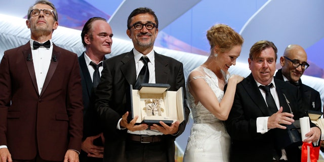 May 24, 2014: Director Nuri Bilge Ceylan, center, poses with the Palme d'Or award for the film Winter Sleep and actor Timothy Spall, second right, poses with his award for Best Actor for his role in the film Mr. Turner during the awards ceremony for the 67th international film festival, Cannes, southern France. (AP)