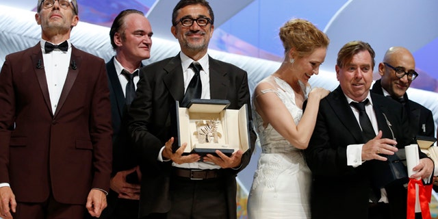 May 24, 2014: Director Nuri Bilge Ceylan, center, poses with the Palme d'Or award for the film Winter Sleep and actor Timothy Spall, second right, poses with his award for Best Actor for his role in the film Mr. Turner during the awards ceremony for the 67th international film festival, Cannes, southern France. (AP)