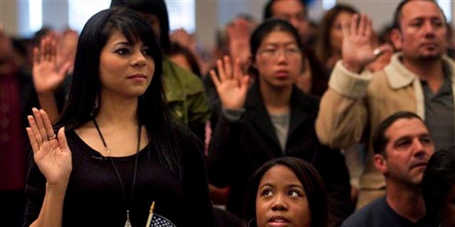 Dec. 15: Shyima Hall, left, takes the oath of citizenship during a citizenship ceremony in Montebello, Calif.